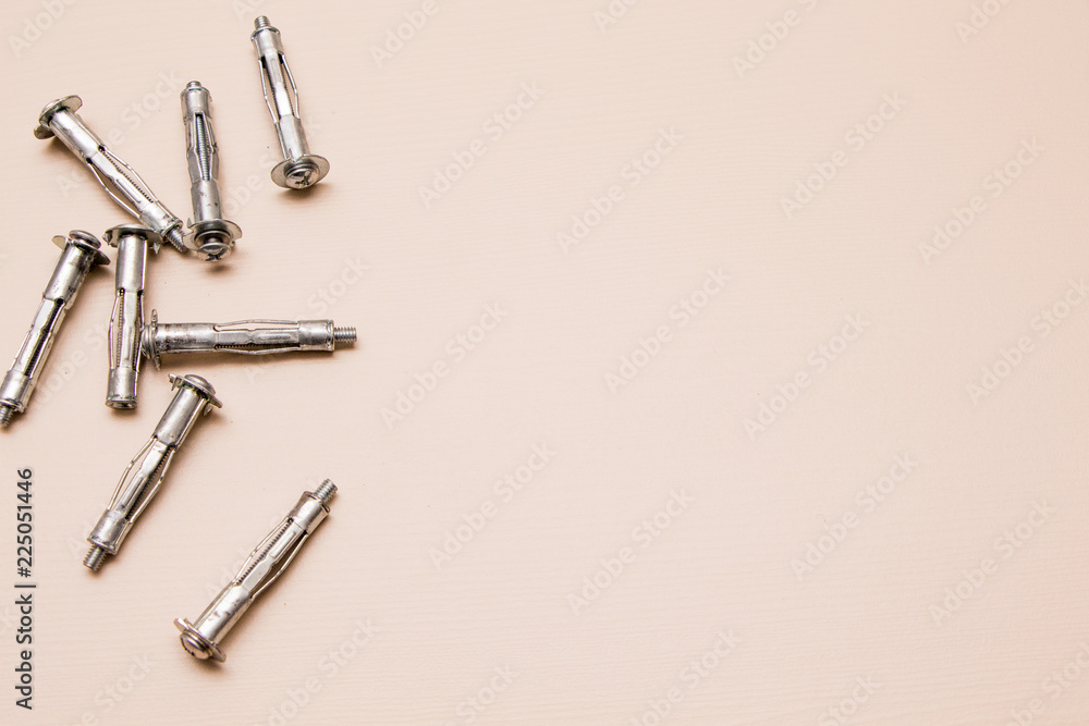 Wall plug or anchor or rawlplug on a wooden background Wall plug or anchor or rawlplug on a wooden background