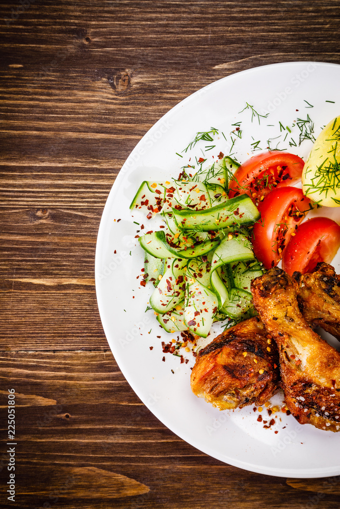 Grilled chicken drumsticks with boiled potatoes and vegetables Grilled chicken drumsticks with boiled potatoes and vegetables