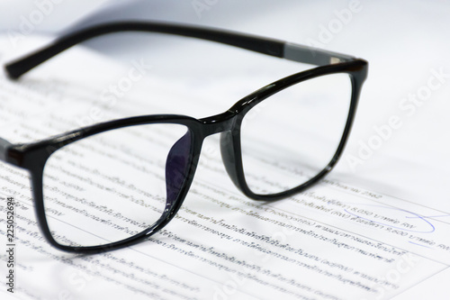 Reading glasses on the paper sheet.