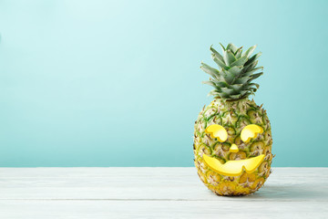 Halloween holiday concept with jack o lantern pineapple