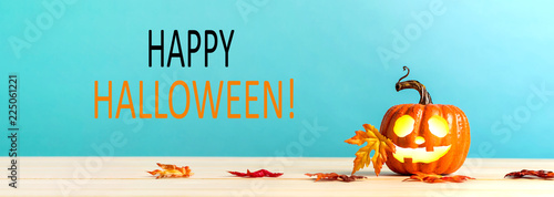 Happy Halloween message with pumpkin with leaves on a blue background