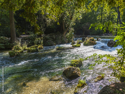 Munich, Germany, on August 22, 2018. Park with stream and artificial wave photo