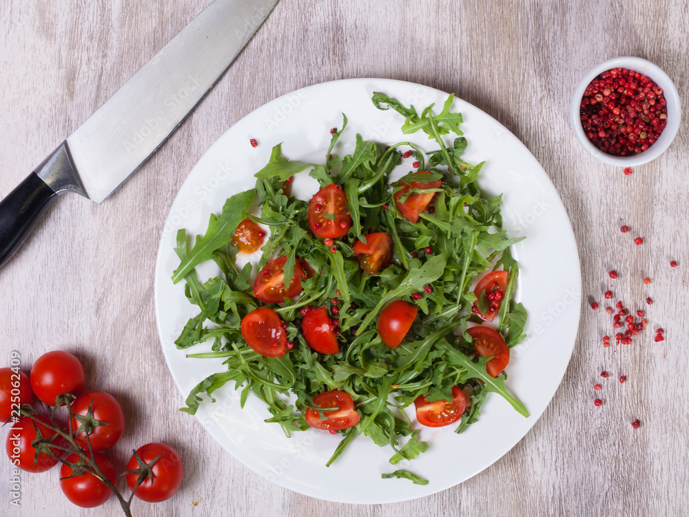 Top view of a salad of tomatoes and arugula Top view of a salad of tomatoes and arugula