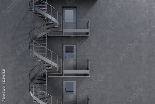 Tablou canvas Gray building with spiral fire escape stairs