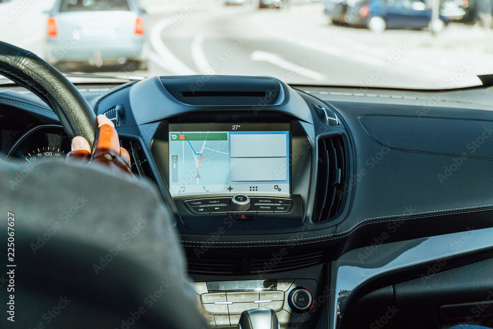 Dashboard View And GPS Map Of Modern Car With Hands Of Man Driver On Steering Wheel