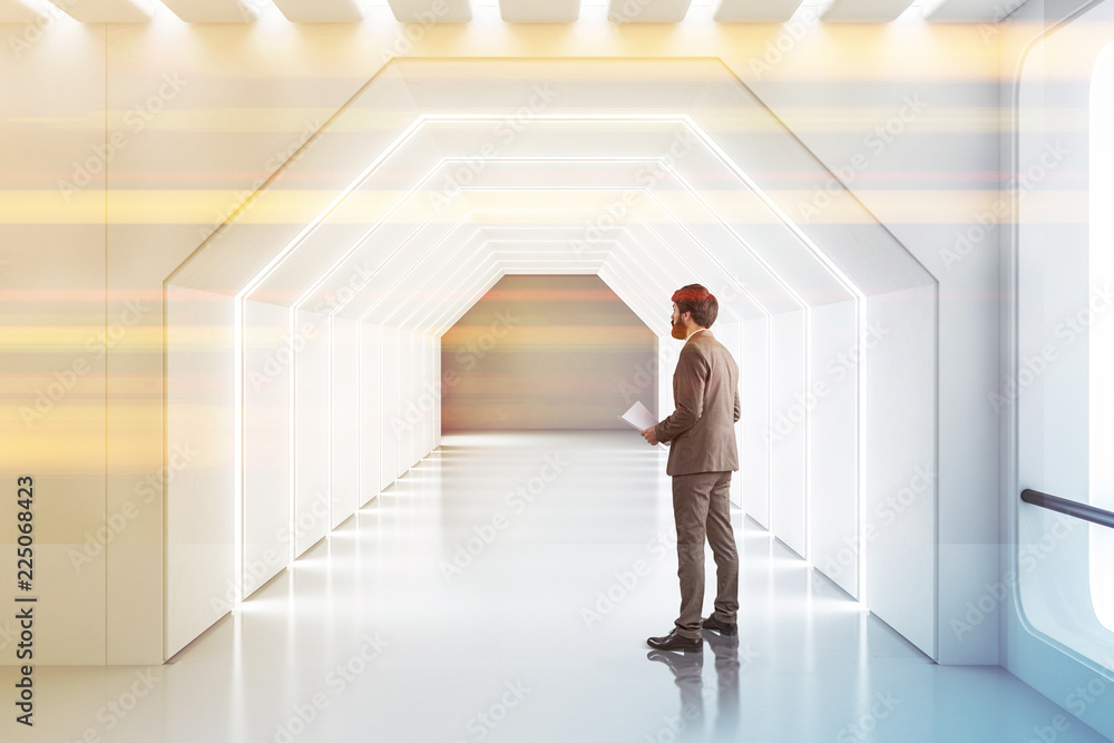 Fototapeta premium Futuristic white corridor, man with papers