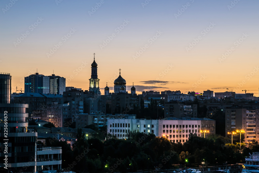 night city view with high-rise buildings and Church