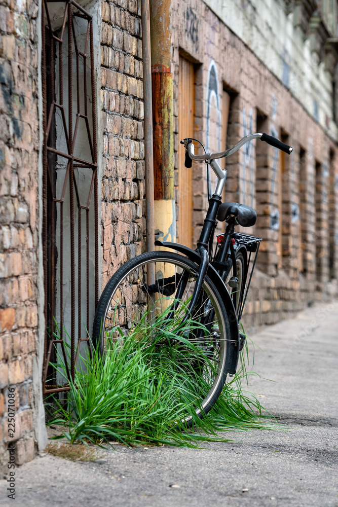 At the old brick building gutters with a lock connected the black bike.