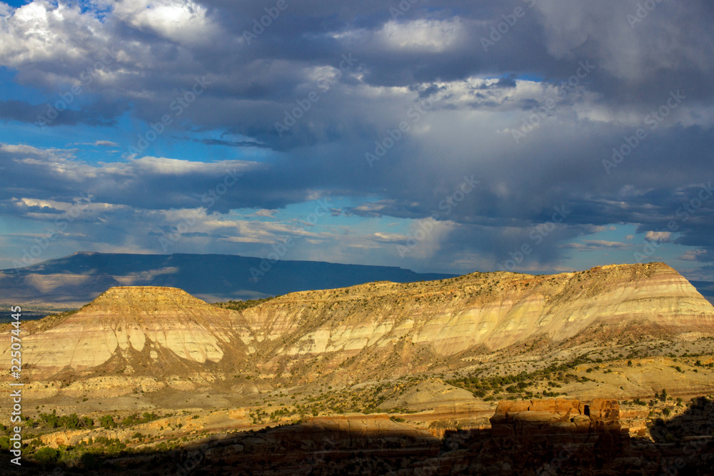 Sunset light on the steep, sloping stone cliffs of Monument Canyon in Colorado National Monument