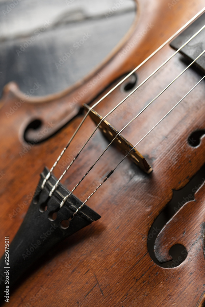A part of a violin or a viola on a wood background A part of a violin or a viola on a wood background