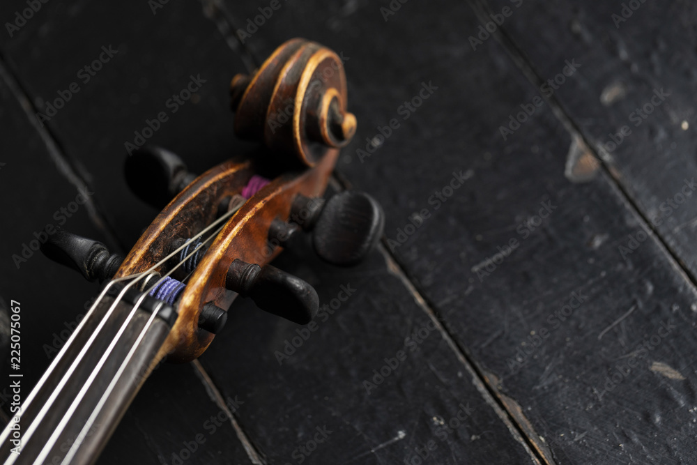 Fototapeta premium A part of a violin or a viola on a wood background