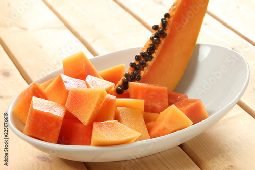 Diced papaya fruit in the white bowl