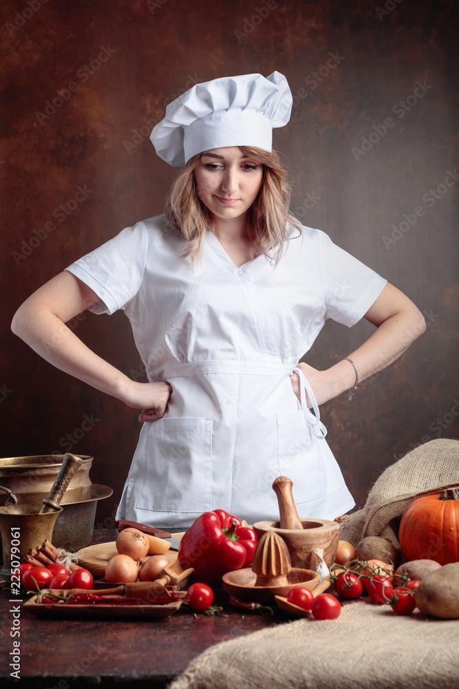 Young beautiful girl in a chef uniform . Young beautiful girl in a chef uniform .