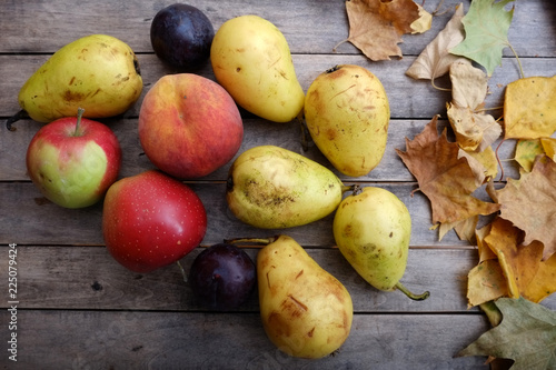 Various colorful fruits on autumn wooden table