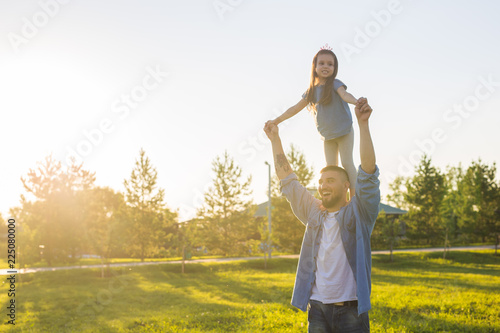 Fatherhood, family and children concept - Father and daughter having fun and playing in nature.