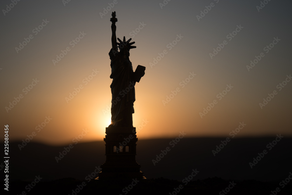 Statue of Liberty on the background of colorful dawn sky Statue of Liberty on the background of colorful dawn sky
