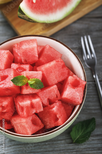 Dessert of sliced ​​slices of watermelon with mint on wooden table, top view
