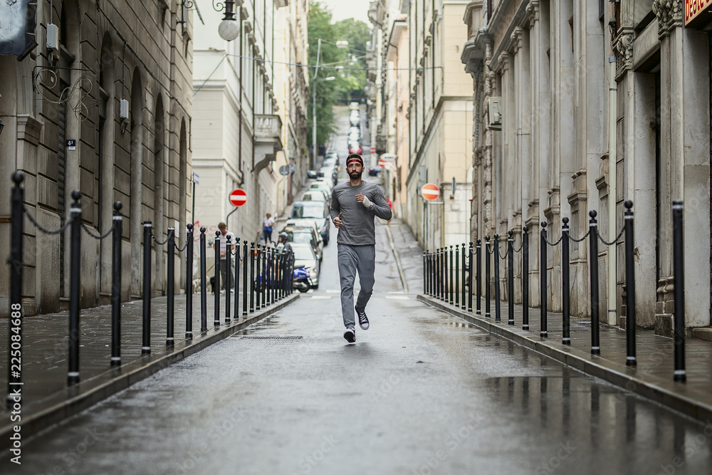 Young man running in the city street