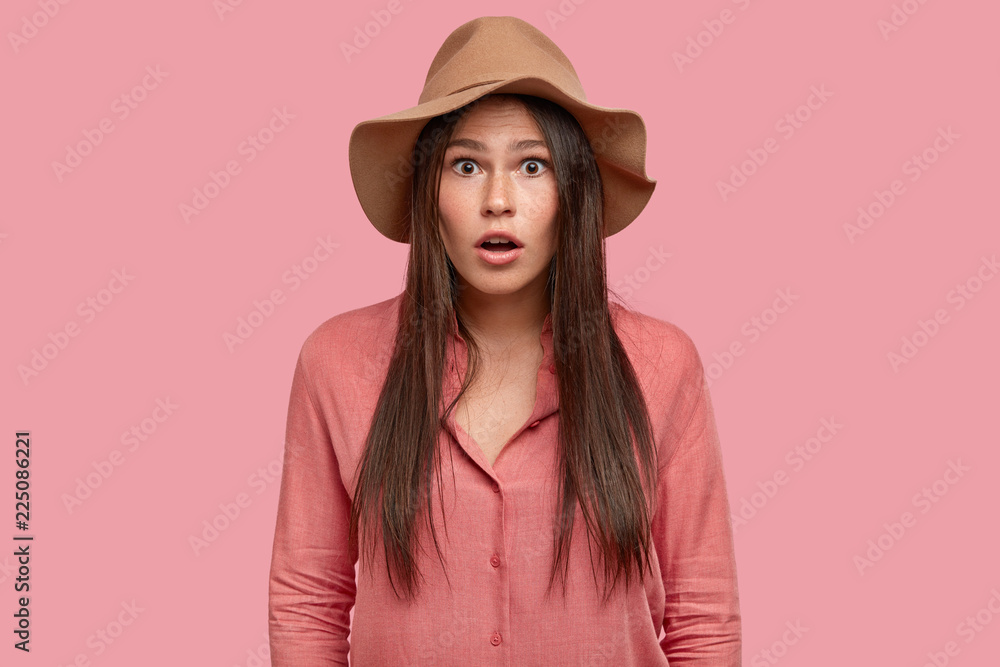 Astonished female traveller being speechless and stunned from amazing gossips, has perplexed, intense expression, shocked with unexpected news, dressed in fashionable outfit. Emotions concept Astonished female traveller being speechless and stunned from amazing gossips, has perplexed, intense expression, shocked with unexpected news, dressed in fashionable outfit. Emotions concept