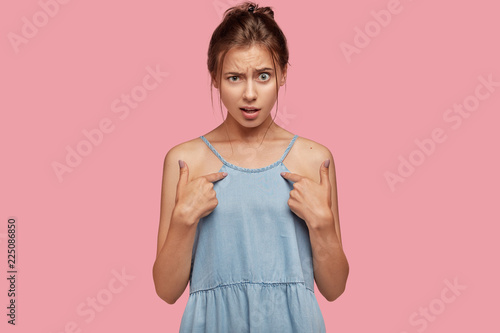 Photo of indignant Caucasian woman points at herself, asks why she should do ...