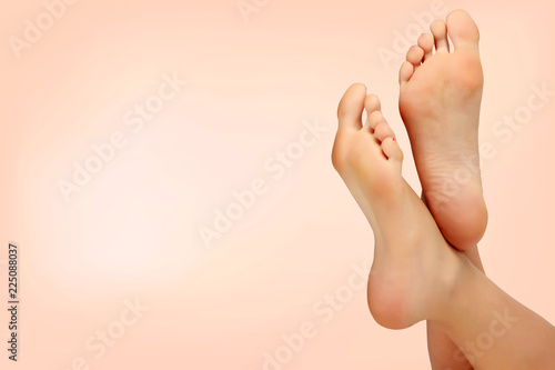 Female feet against pastel background. Skin care concept photo