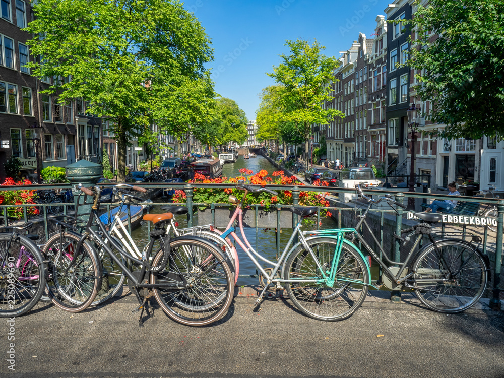 Beautiful view of Amsterdam canals with bridge and bikes. Amsterdam, Netherlands