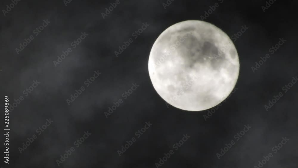 Full Moon in a cloudy night sky with clouds moving around. Close up 4k video Full Moon in a cloudy night sky with clouds moving around. Close up 4k video