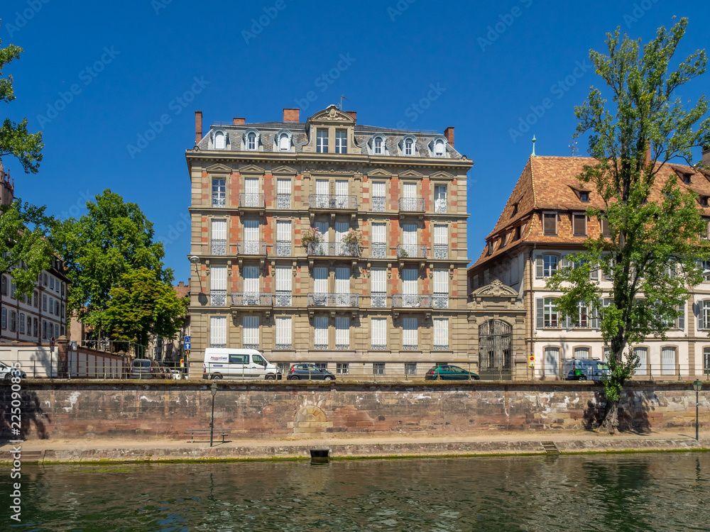 Fototapeta premium View along the Ill River in historic areas of Strasbourg in the Alsace region of France. 