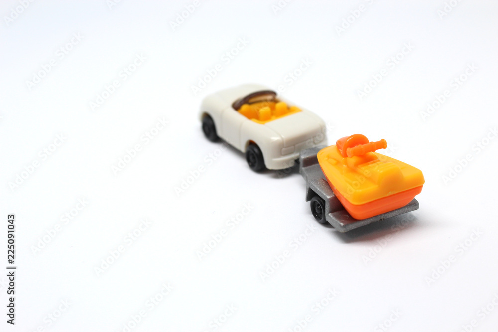 Isolated White Toy Car With Trailer Which Carrying Jetski On It Isolated White Toy Car With Trailer Which Carrying Jetski On It