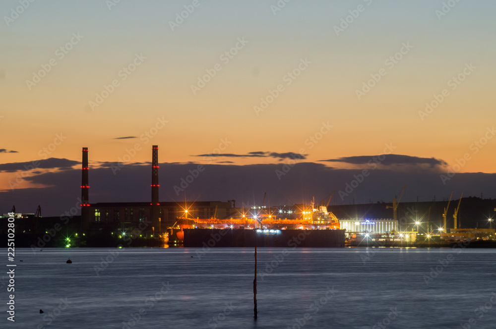 Bulgarian industrial port at night with cranes