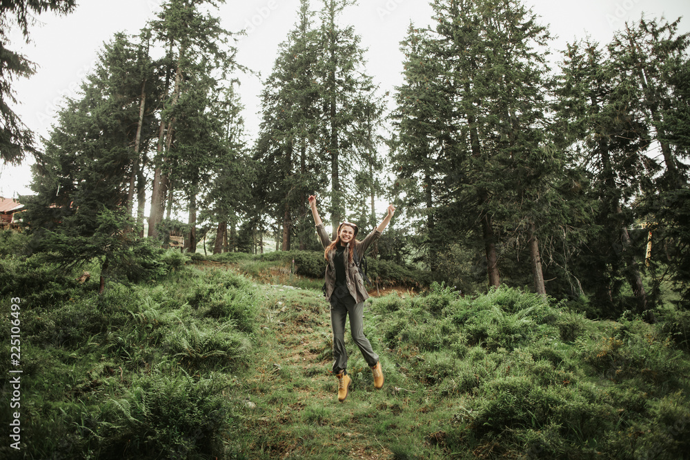 I can fly. Full length portrait of excited young lady expressing happiness in beautiful coniferous wood I can fly. Full length portrait of excited young lady expressing happiness in beautiful coniferous wood