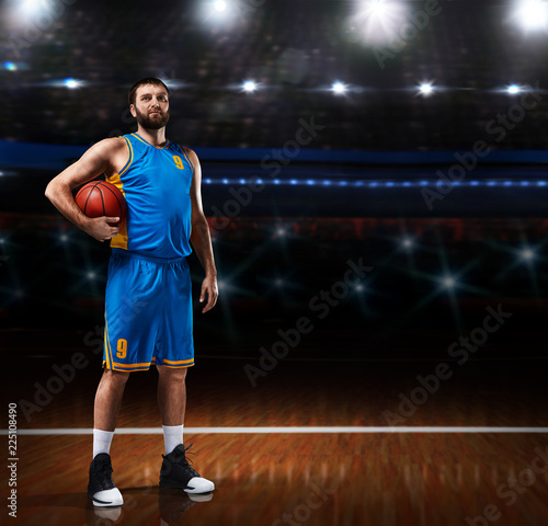basketball player im blue uniform standing on basketball court