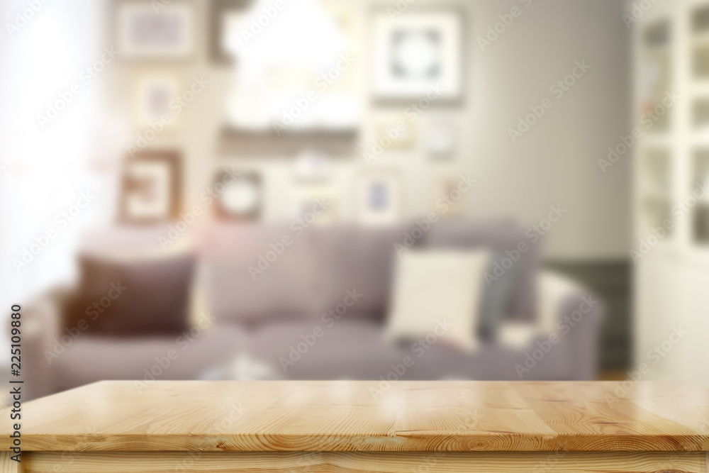 Empty wooden table over living room background. Empty wooden table over living room background.