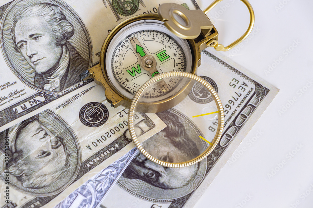 Defective compass placed on the United States dollar banknotes. The concept of direction of financial or investment at present and in the future. Defective compass placed on the United States dollar banknotes. The concept of direction of financial or investment at present and in the future.