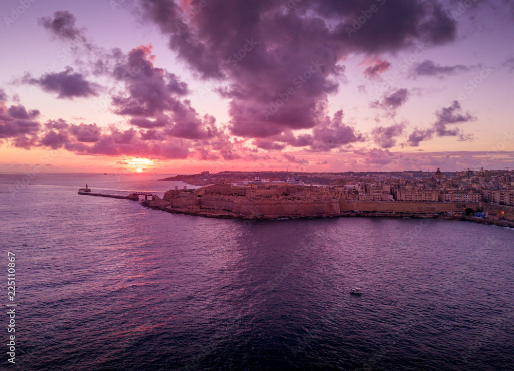La Valletta sunrise with purple, orange, red, yellow sky in Malta La Valletta sunrise with purple, orange, red, yellow sky in Malta