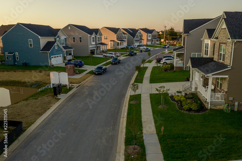 Fototapeta Naklejka Na Ścianę i Meble -  American single family homes at a East Coast Maryland USA new construction aerial view at sunset with vynil siding for upper middle class families