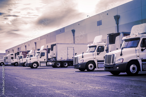 Carta da parati Trucks loading unloading at warehouse  shipping logistics transport concept imag