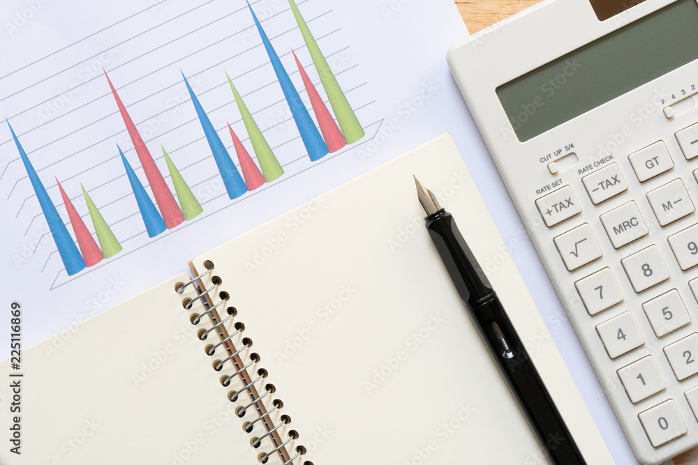 Calculators and pens put on stock chart Investment Analysis Or investment Sales rankings are targeted to determine the flag. using as background business concept with copy space and white space. Calculators and pens put on stock chart Investment Analysis Or investment Sales rankings are targeted to determine the flag. using as background business concept with copy space and white space.