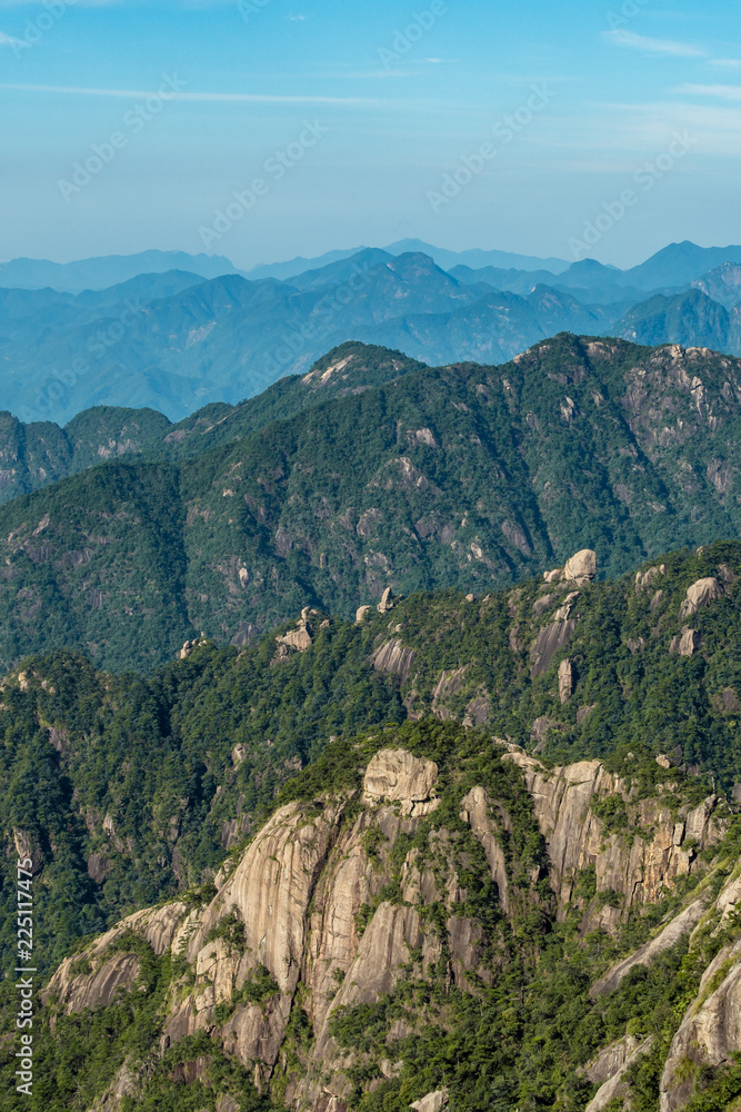 Fototapeta premium forest covered valley floor under blue hazy at mount sanqing geo park