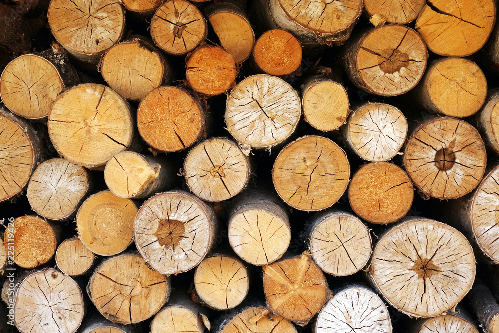 Chopped wood laid in a woodpile to dry for the winter. Wood texture. Chopped wood laid in a woodpile to dry for the winter. Wood texture.