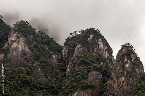 green covered mountain peaks under the thick mist