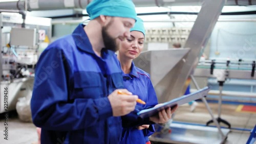 Two employees go through an industrial plant
