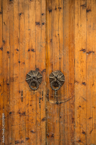 brown Chinese wooden doors with rusted metal door nobs