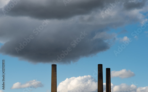 The old chimneys with the dark clouds above