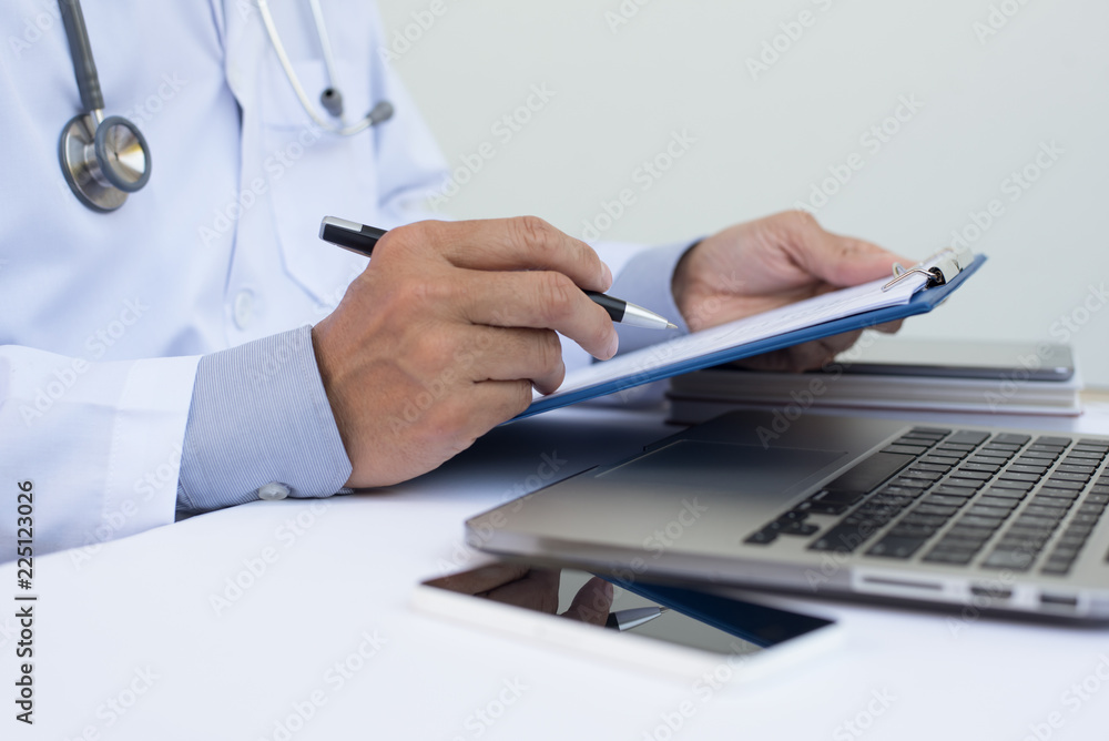 Doctor working on laptop computer Doctor working on laptop computer