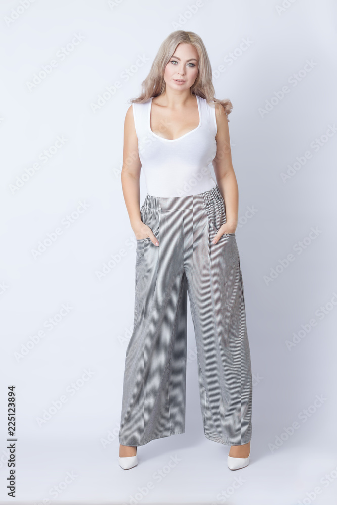 Fototapeta premium Full length portrait of cheerful blonde woman
