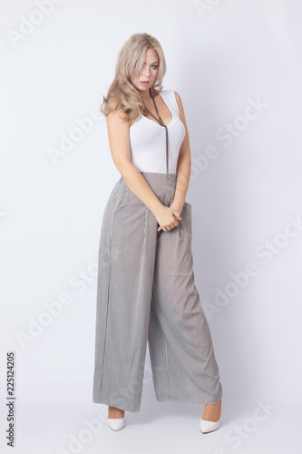 Full length portrait of cheerful blonde woman