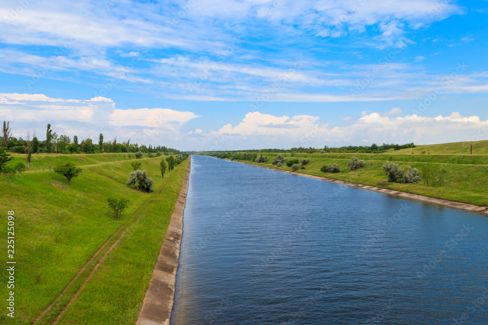 Fototapeta premium View on the irrigation canal on summer