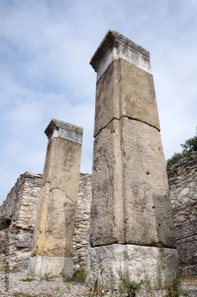 two columns and the ruins of an ancient city