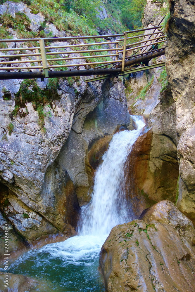Fototapeta premium Mixnitz, Austria and its popular hiking trail in a gorge full of wateralls and wooden paths called Baerenschutzklamm